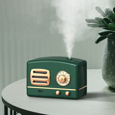 Stylish decorative humidifier for home in green, resembling a vintage radio with mist emission